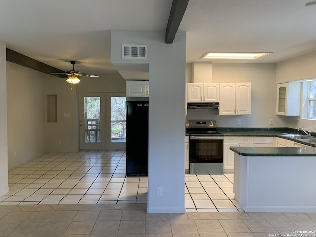 1076 Eastview, Canyon Lake, TX 78133 - kitchen with stainless steel range with electric stovetop, freestanding refrigerator, a sink, dark countertops, and light tile patterned floors