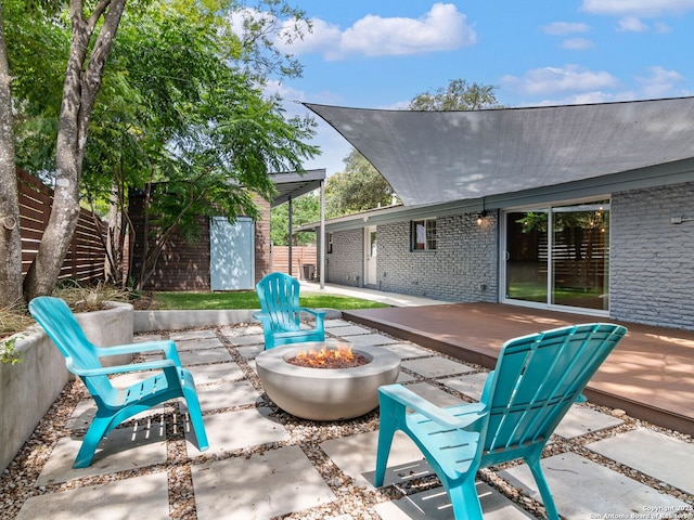 602 Northridge, San Antonio, TX 78209 - view of patio / terrace featuring a fire pit, a deck, and an outbuilding