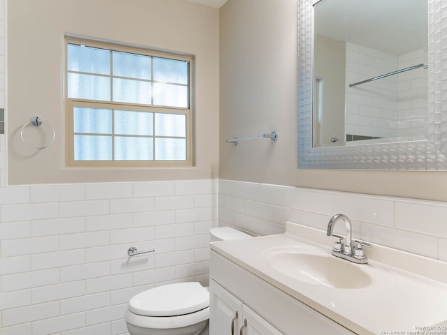 602 Northridge, San Antonio, TX 78209 - bathroom with tile walls, vanity, toilet, a shower, and a wainscoted wall