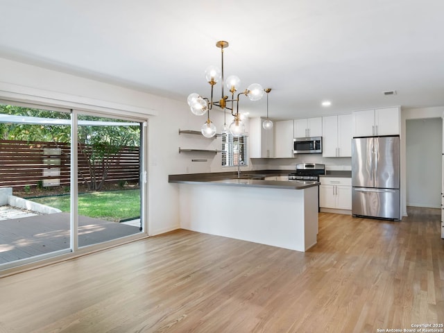 602 Northridge, San Antonio, TX 78209 - kitchen featuring appliances with stainless steel finishes, dark countertops, healthy amount of natural light, and white cabinetry