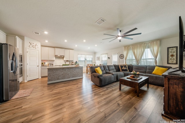 948 Black Horse Way, San Antonio, TX 78260 - living room with a ceiling fan, light wood-style floors, and recessed lighting