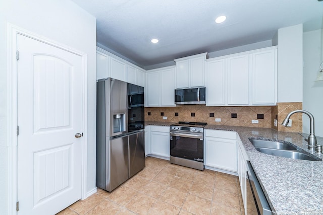 7735 Brisbane Bnd, Converse, TX 78109 - kitchen featuring stainless steel appliances, a sink, white cabinets, and recessed lighting