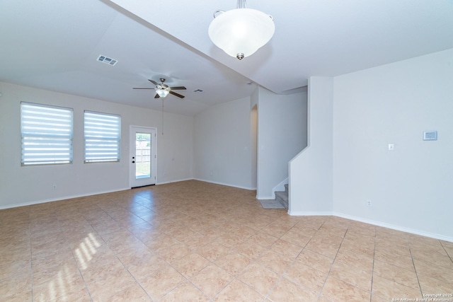 7735 Brisbane Bnd, Converse, TX 78109 - unfurnished room featuring stairs, a ceiling fan, baseboards, vaulted ceiling, and light tile patterned flooring