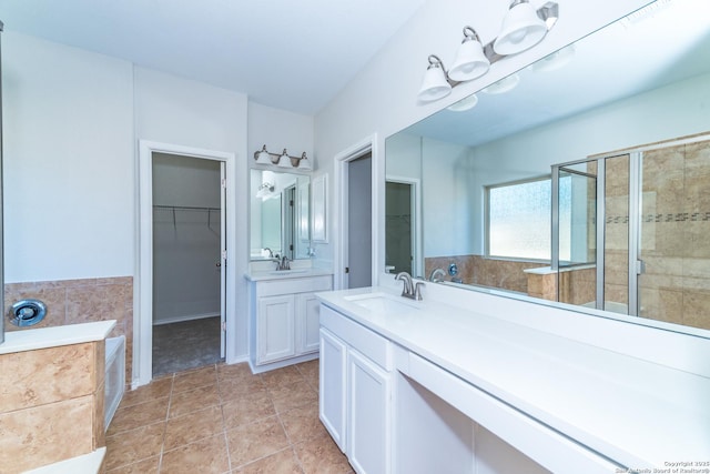 7735 Brisbane Bnd, Converse, TX 78109 - bathroom with two vanities, a garden tub, a walk in closet, a shower stall, and tile patterned floors