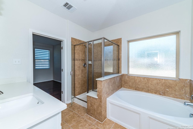 7735 Brisbane Bnd, Converse, TX 78109 - full bathroom with healthy amount of natural light, a bath, a shower stall, and tile patterned floors