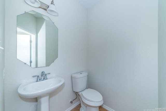 7735 Brisbane Bnd, Converse, TX 78109 - half bath with toilet, baseboards, and a sink