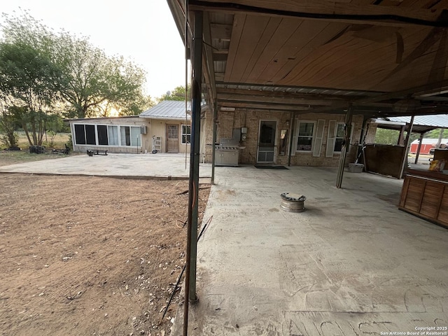 512 Brown Ln, Floresville, TX 78114 - rear view of property featuring a patio area and metal roof