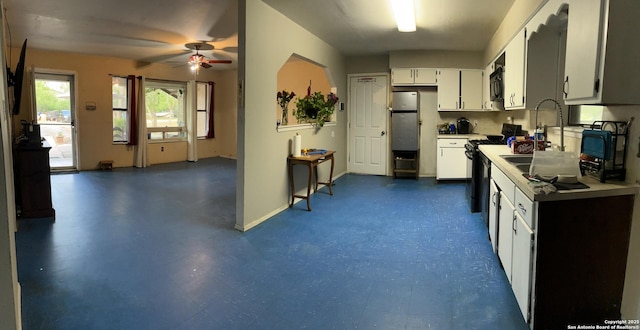 512 Brown Ln, Floresville, TX 78114 - kitchen with black appliances, ceiling fan, white cabinets, and light countertops