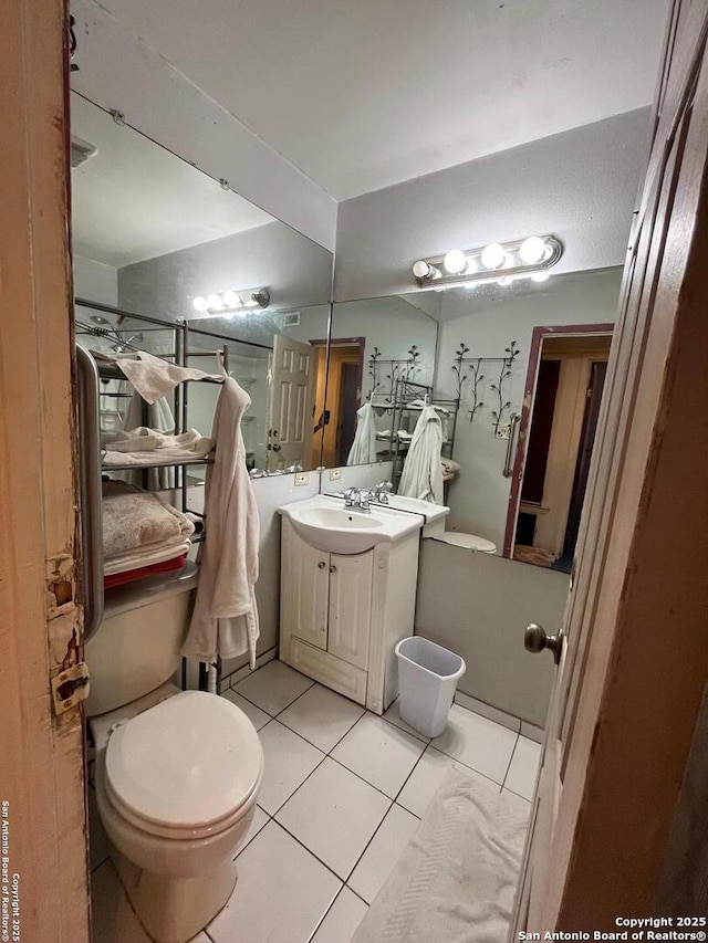 512 Brown Ln, Floresville, TX 78114 - bathroom featuring toilet, vanity, and tile patterned flooring