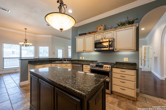 8718 Paseo Oaks, San Antonio, TX 78255 - kitchen with appliances with stainless steel finishes, stone tile flooring, a peninsula, a sink, and ornamental molding