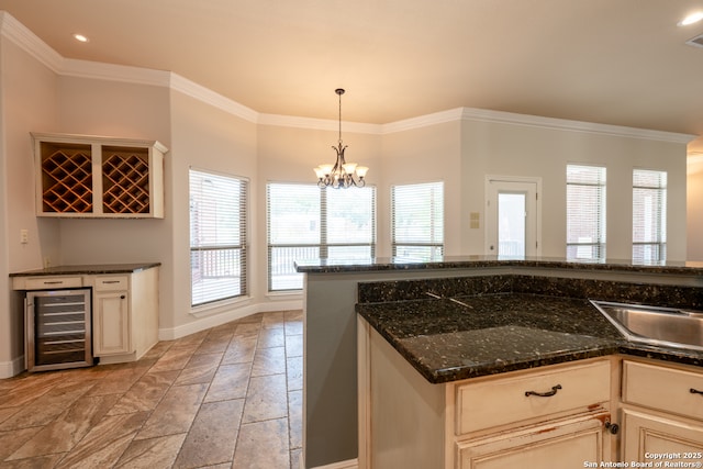 8718 Paseo Oaks, San Antonio, TX 78255 - kitchen with beverage cooler, stone tile flooring, baseboards, healthy amount of natural light, and crown molding