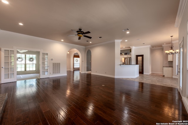 8718 Paseo Oaks, San Antonio, TX 78255 - unfurnished living room with hardwood / wood-style flooring, a ceiling fan, arched walkways, a chandelier, and recessed lighting