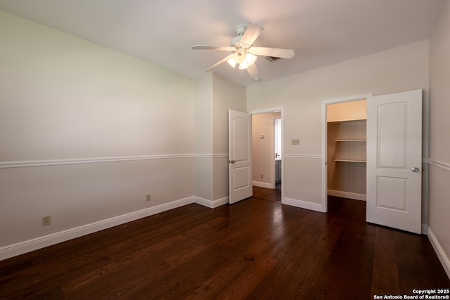 8718 Paseo Oaks, San Antonio, TX 78255 - unfurnished bedroom with dark wood-type flooring, baseboards, a spacious closet, and a ceiling fan