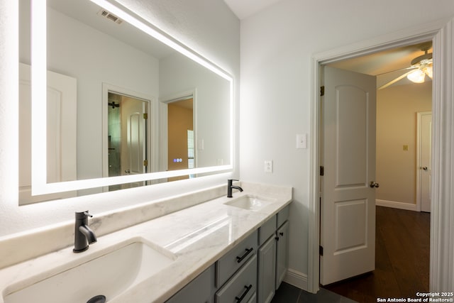 8718 Paseo Oaks, San Antonio, TX 78255 - full bath featuring double vanity, ceiling fan, wood finished floors, and baseboards
