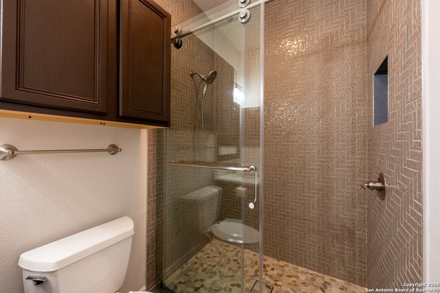 8718 Paseo Oaks, San Antonio, TX 78255 - bathroom featuring toilet and a shower stall