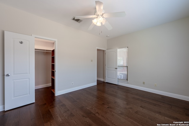 8718 Paseo Oaks, San Antonio, TX 78255 - unfurnished bedroom featuring dark wood-style flooring, baseboards, a walk in closet, a ceiling fan, and a closet