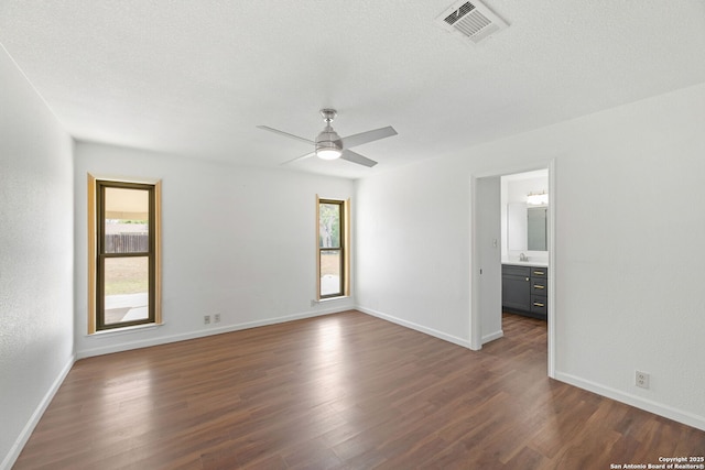 1312 Acorn, Hondo, TX 78861 - unfurnished room with dark wood-style floors, baseboards, ceiling fan, and a sink