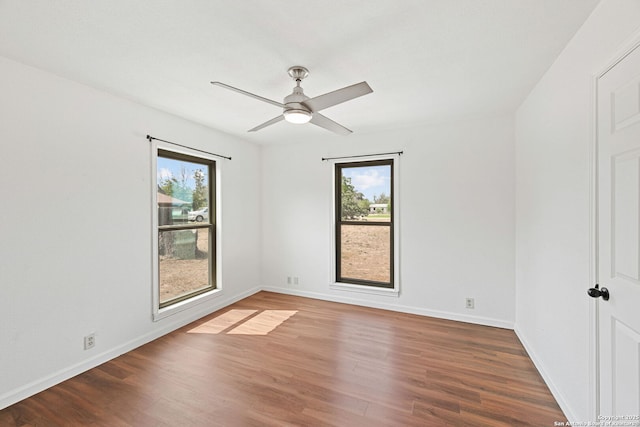 1312 Acorn, Hondo, TX 78861 - empty room featuring healthy amount of natural light, wood finished floors, and baseboards