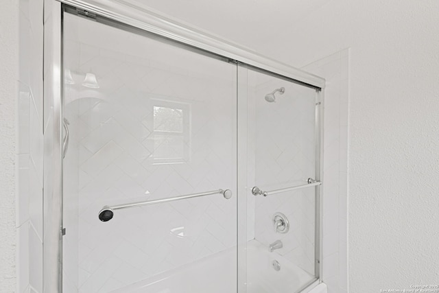 1312 Acorn, Hondo, TX 78861 - bathroom featuring bath / shower combo with glass door