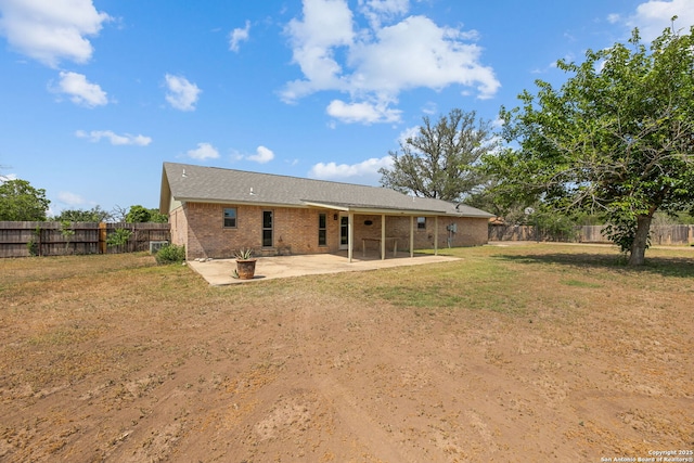 1312 Acorn, Hondo, TX 78861 - back of house featuring a patio and brick siding