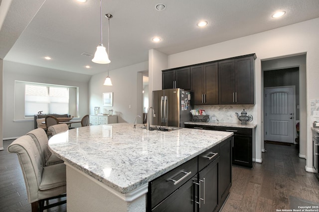 25514 Vista Bella, San Antonio, TX 78260 - kitchen with freestanding refrigerator, a sink, dark wood finished floors, light stone countertops, and recessed lighting