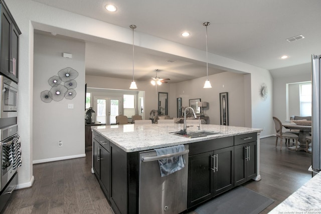25514 Vista Bella, San Antonio, TX 78260 - kitchen with appliances with stainless steel finishes, a sink, open floor plan, dark wood-style floors, and a kitchen island with sink
