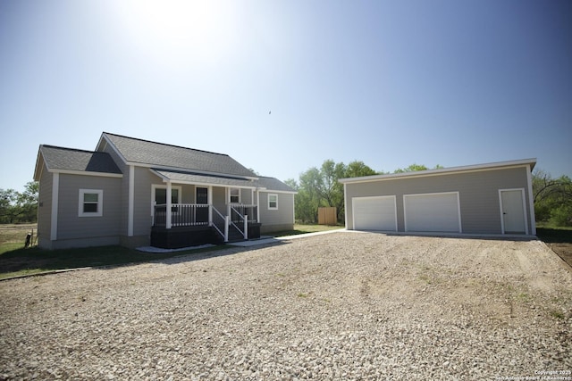 1556 County Road 2537, Moore, TX 78057 - view of front of property featuring a porch, driveway, an outdoor structure, and a detached garage
