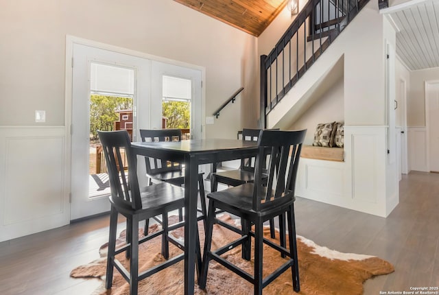 1556 County Road 2537, Moore, TX 78057 - dining room featuring wood ceiling, a decorative wall, a wainscoted wall, vaulted ceiling, and stairway