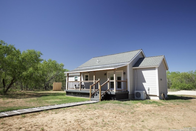 1556 County Road 2537, Moore, TX 78057 - back of property featuring a cooling unit, covered porch, roof with shingles, and a lawn