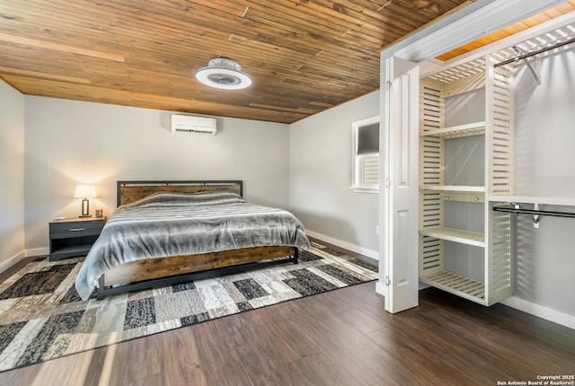 1556 County Road 2537, Moore, TX 78057 - bedroom featuring an AC wall unit, baseboards, wood finished floors, and wooden ceiling