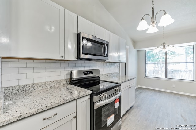 4203 Quail, San Antonio, TX 78217 - kitchen featuring appliances with stainless steel finishes, a chandelier, backsplash, and light wood-style floors