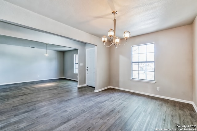 4203 Quail, San Antonio, TX 78217 - empty room featuring dark wood-style floors, baseboards, and a chandelier