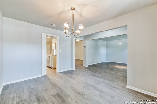 4203 Quail, San Antonio, TX 78217 - empty room featuring a chandelier, baseboards, and wood finished floors