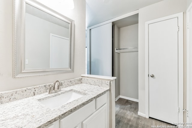 4203 Quail, San Antonio, TX 78217 - bathroom with wood finished floors, vanity, and baseboards