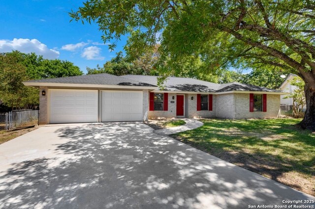4203 Quail, San Antonio, TX 78217 - ranch-style home with a garage, driveway, and brick siding