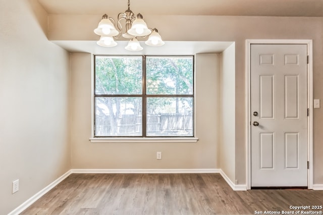 4203 Quail, San Antonio, TX 78217 - unfurnished dining area with a chandelier, wood finished floors, and baseboards