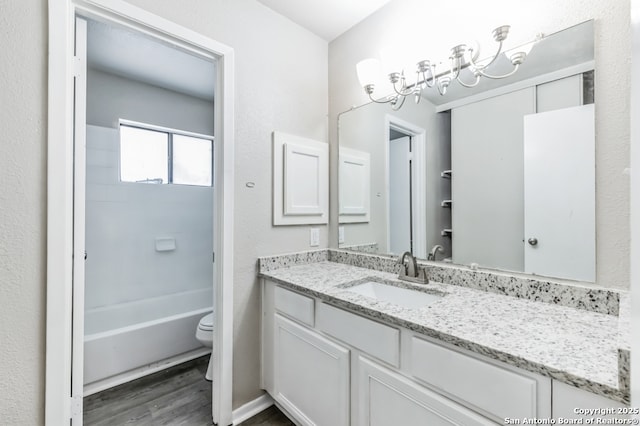 4203 Quail, San Antonio, TX 78217 - full bath with wood finished floors, vanity, toilet, a chandelier, and bathtub / shower combination