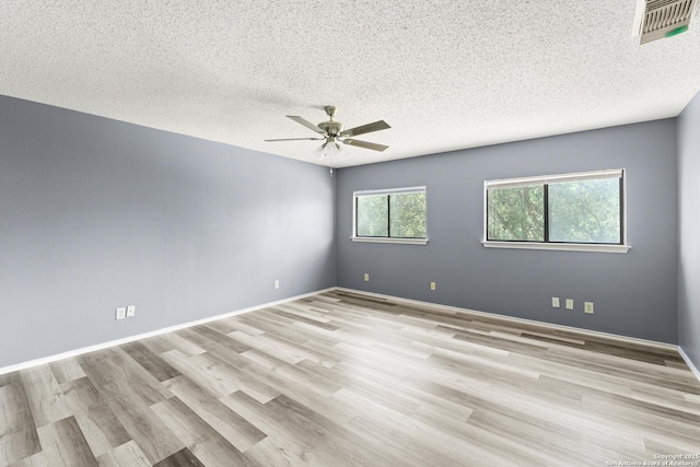 8134 Cheryl Mdw, Converse, TX 78109 - unfurnished room with a ceiling fan, wood finished floors, a textured ceiling, and baseboards