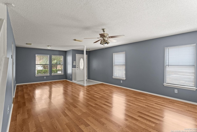8134 Cheryl Mdw, Converse, TX 78109 - empty room with wood finished floors, ceiling fan, a textured ceiling, and baseboards