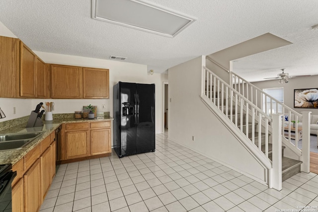 8134 Cheryl Mdw, Converse, TX 78109 - kitchen featuring black appliances, a sink, a textured ceiling, brown cabinetry, and a ceiling fan