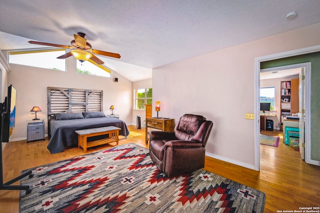 1231 Montell, Wimberley, TX 78676 - bedroom featuring wood finished floors, lofted ceiling, baseboards, a textured ceiling, and ceiling fan