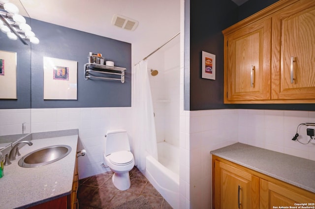 1231 Montell, Wimberley, TX 78676 - bathroom featuring tile walls, vanity, tile patterned floors, toilet, and shower / tub combo with curtain