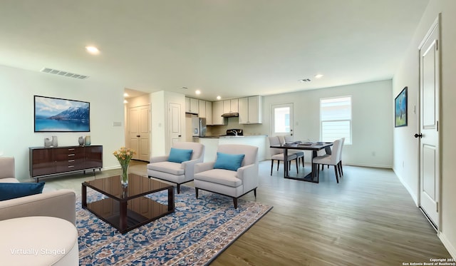 4211 Cove, San Antonio, TX 78223 - living room with light wood finished floors, baseboards, and recessed lighting