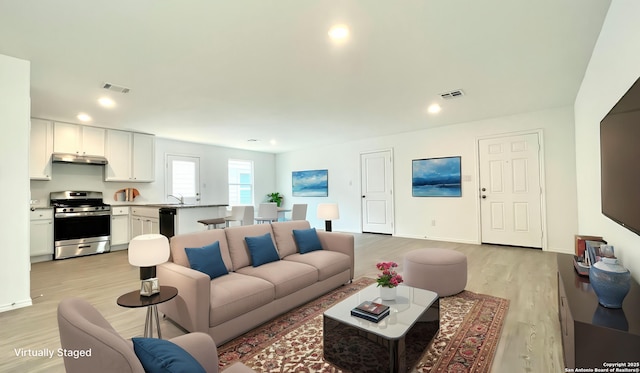 4211 Cove, San Antonio, TX 78223 - living room with light wood finished floors, recessed lighting, and baseboards