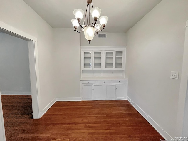 436 W Gramercy Pl, San Antonio, TX 78212 - unfurnished dining area featuring a chandelier, dark wood-style floors, and baseboards