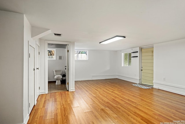 6806 Arrow, San Antonio, TX 78256 - interior space featuring light wood-style flooring, baseboards, and an AC wall unit