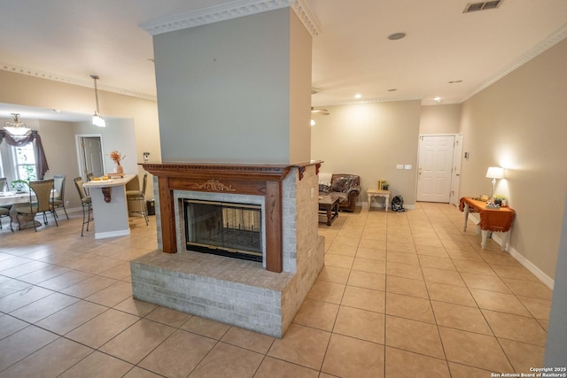 633 Sunrise Ave, Uvalde, TX 78801 - living area featuring light tile patterned flooring, crown molding, a ceiling fan, a glass covered fireplace, and baseboards