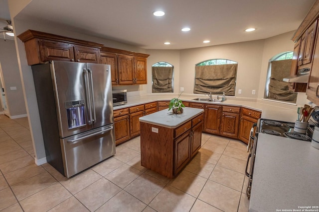 633 Sunrise Ave, Uvalde, TX 78801 - kitchen featuring appliances with stainless steel finishes, recessed lighting, exhaust hood, a sink, and light tile patterned floors