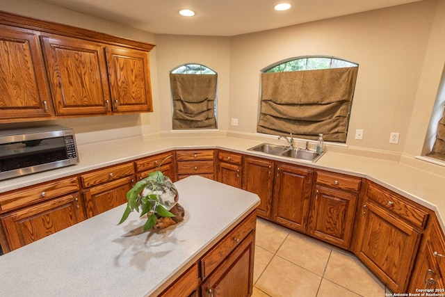 633 Sunrise Ave, Uvalde, TX 78801 - kitchen with a sink, stainless steel microwave, light countertops, healthy amount of natural light, and recessed lighting