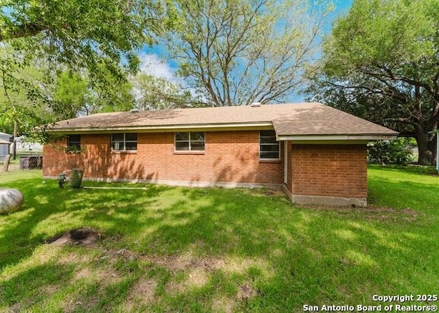 36 County Road 346c, Shiner, TX 77984 - rear view of property featuring a yard and brick siding